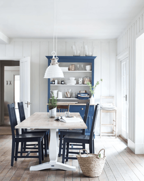 white cottage style dining room with marine blue hutch