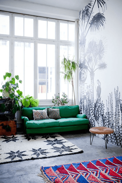 white living room with emerald green sofa