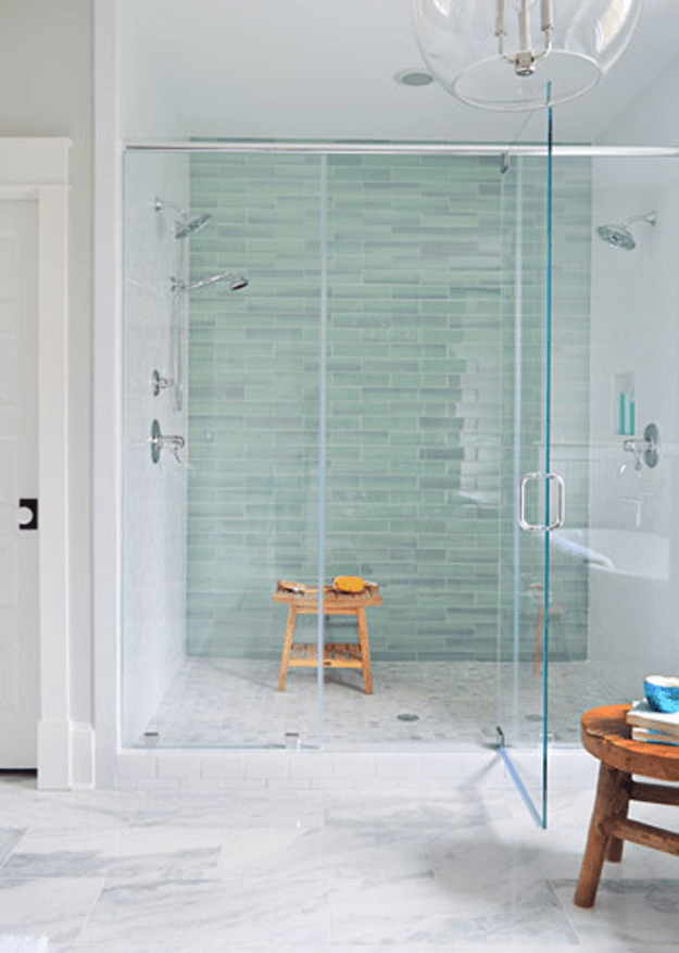 white modern bathroom with mint green tile accent wall