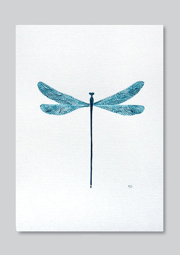 teal blue dragonfly on white paper