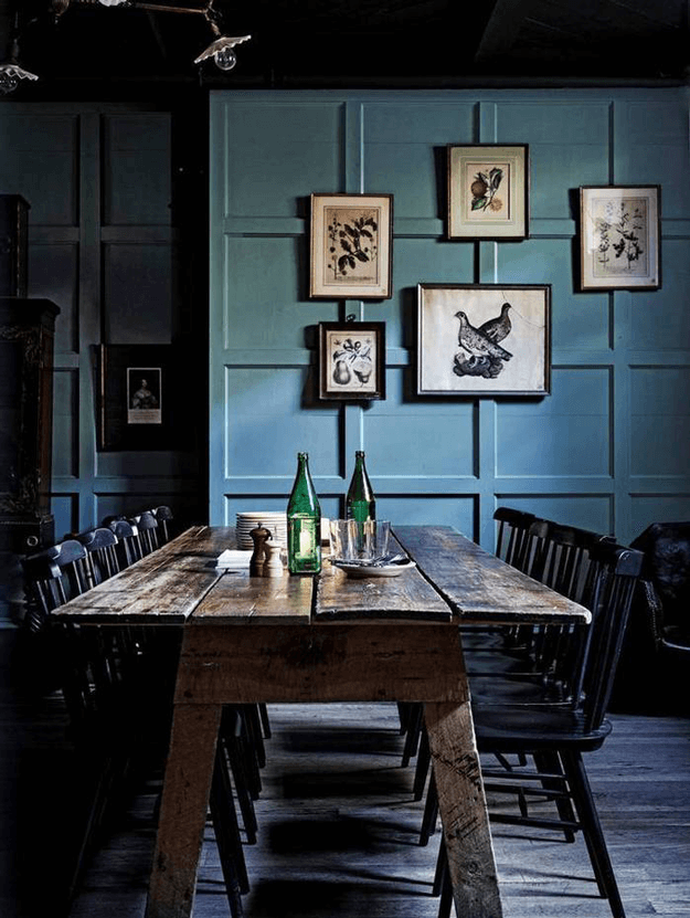 dark dining room with slate blue paneled walls