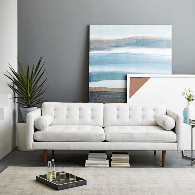 white tufted modern sofa in gray living room