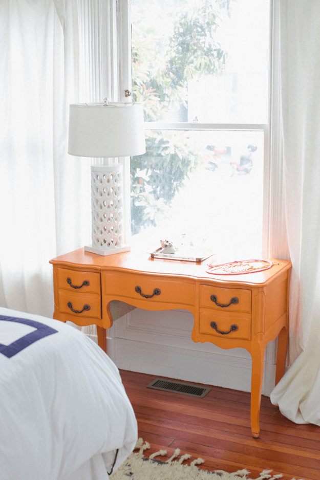 white bedroom with orange desk