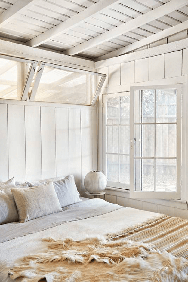 cottage style bedroom with beige hide throw