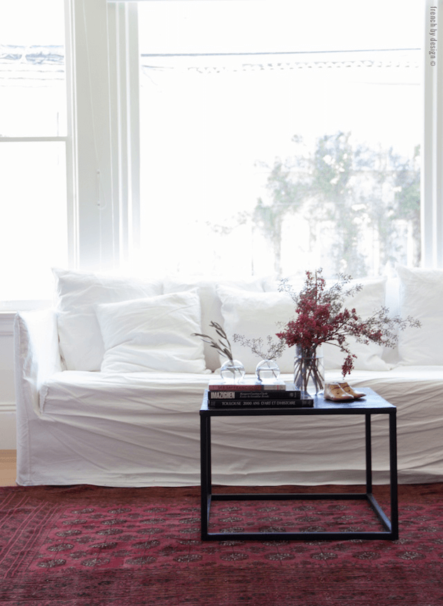 white living room with burgundy rug