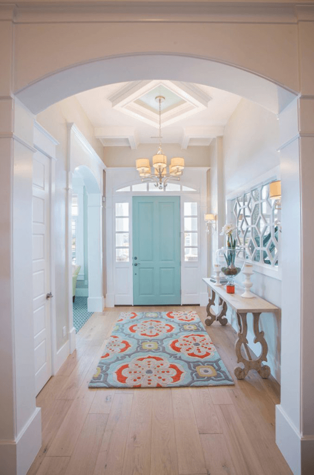 white home foyer with light turquoise door