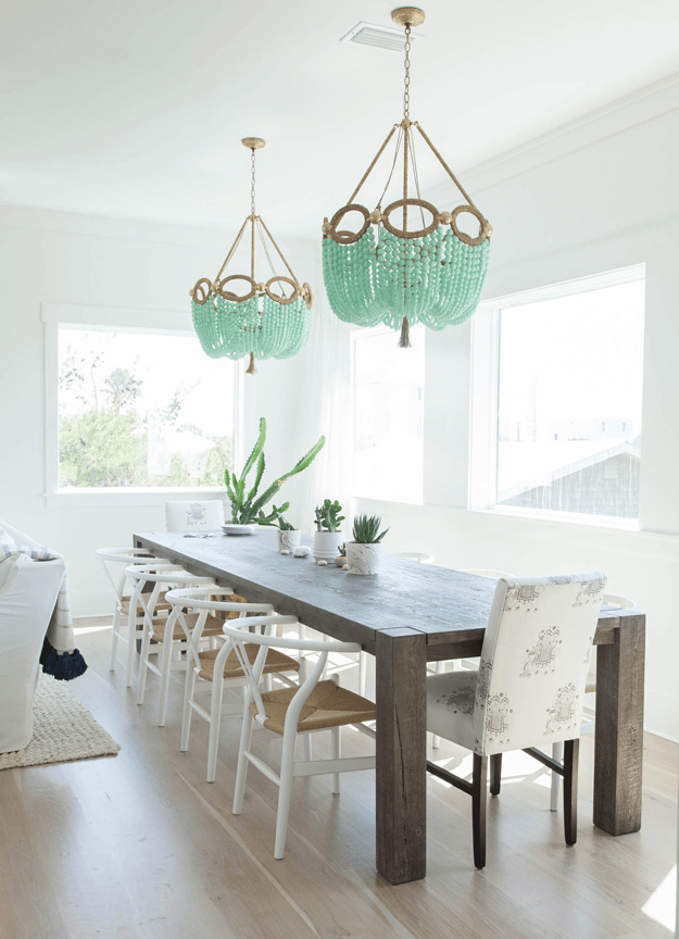 white dining room with mint green chandeliers
