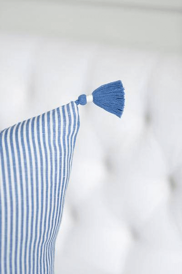 french blue striped pillow on white chair