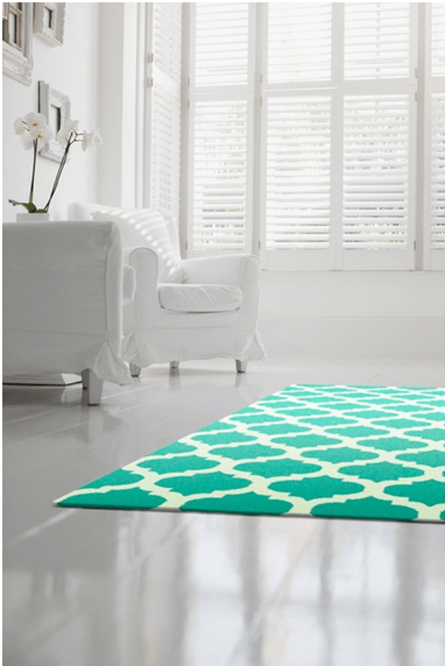 white living room with jade green patterned rug