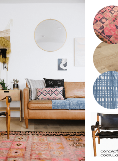 A MODERN BOHO LIVING ROOM WITH VINTAGE RUGS AND A SAFARI CHAIR