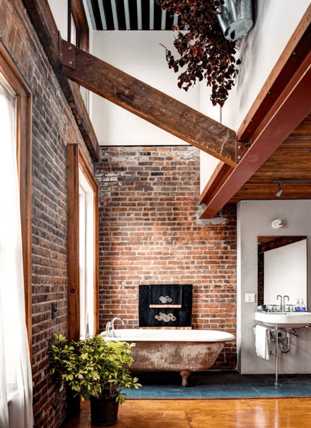 loft bathroom with red brick walls