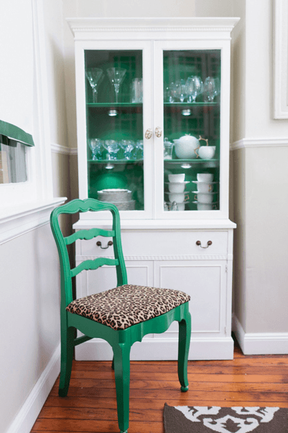 white dining room with emerald green accents