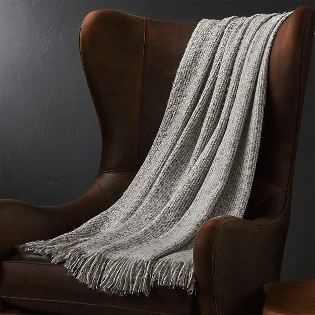 olive gray throw blankete over burgundy chair