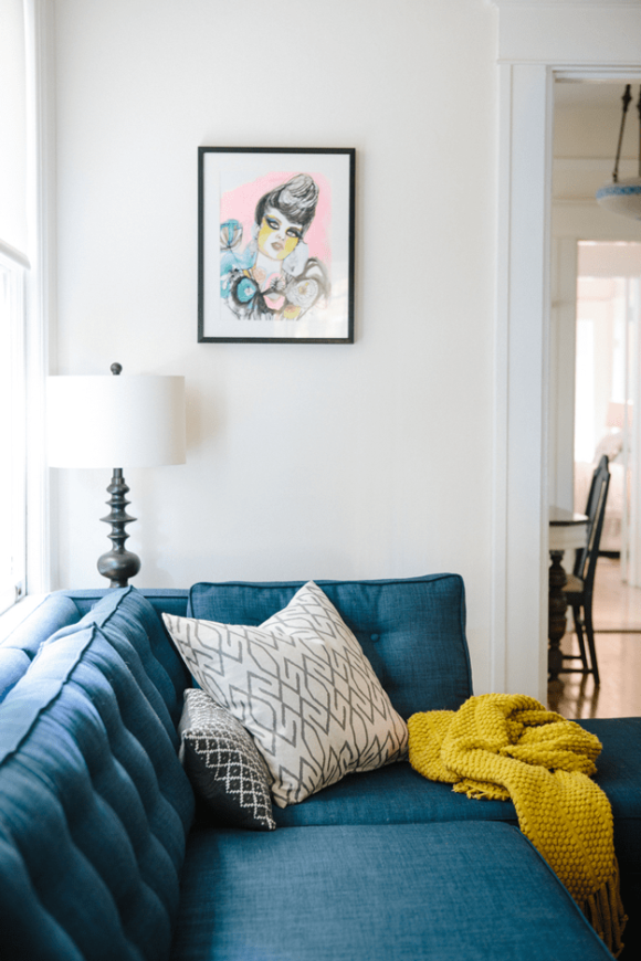 white living room with peacock blue modern sectional
