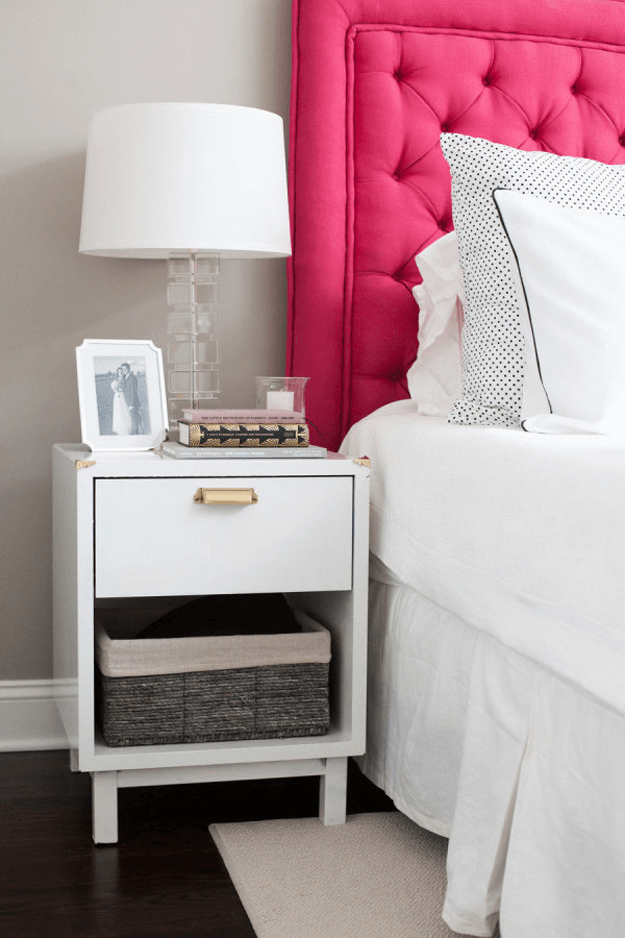 gray and white bedroom with hot pink headboard