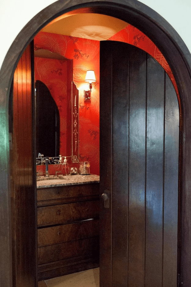 bright red bathroom with dark wood door