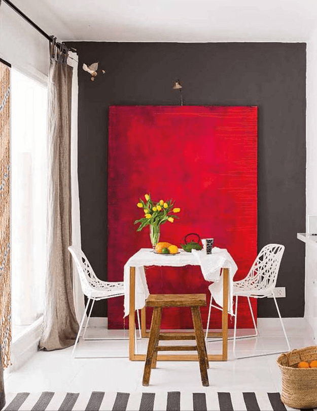 gray and white dining room with bright red accent panel