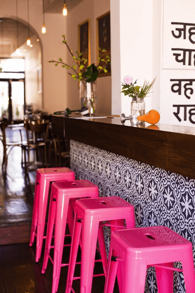 indian canteen restaurant interior with hot pink stools