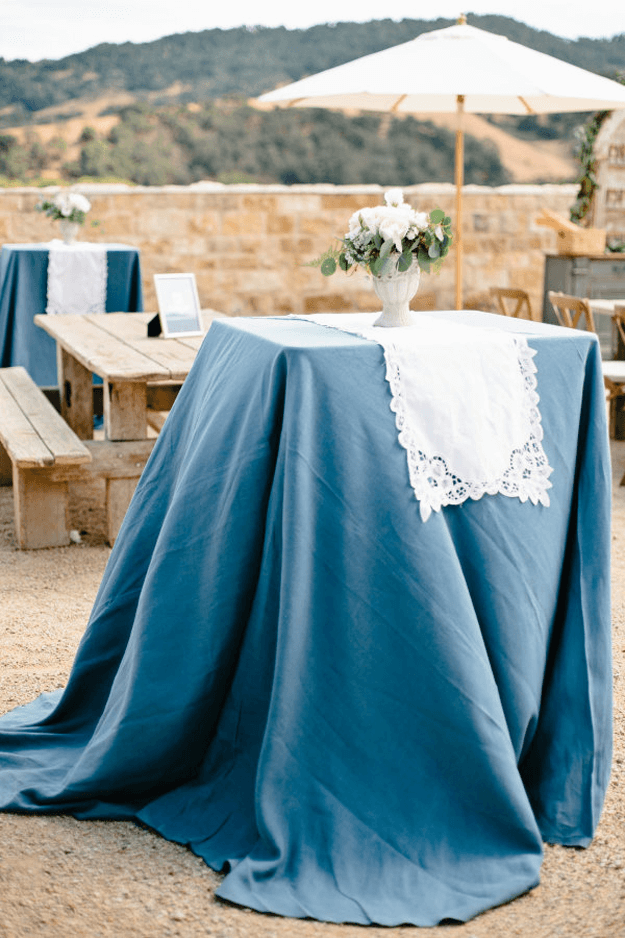 outdoor patio wedding with slate blue table cloths