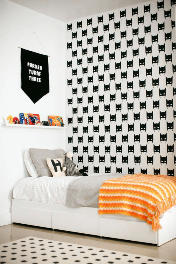 white bedroom with batman wallpaper accent wall