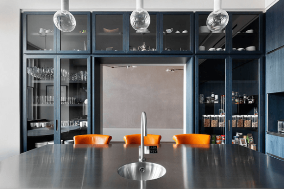 dark modern interior with burnt orange bar stools