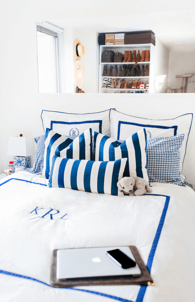 white bedroom with bright blue striped bedding