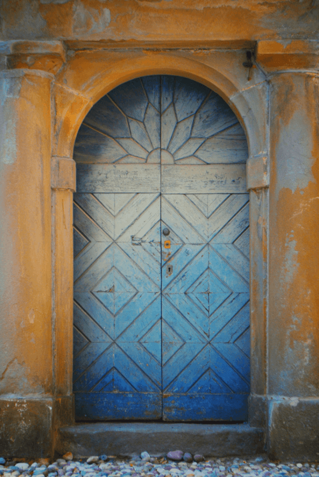 faded blue italian door in rust orange wall