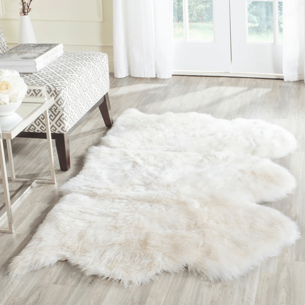 white sheepskin throw rug in ivory and gray room