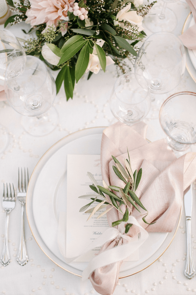 white table setting with pale pink and green accents