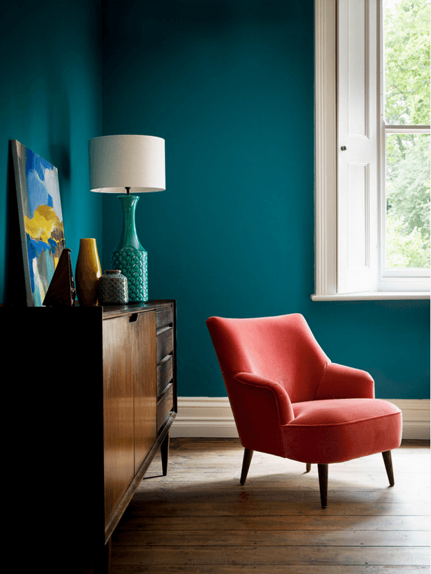 teal blue room with red chair