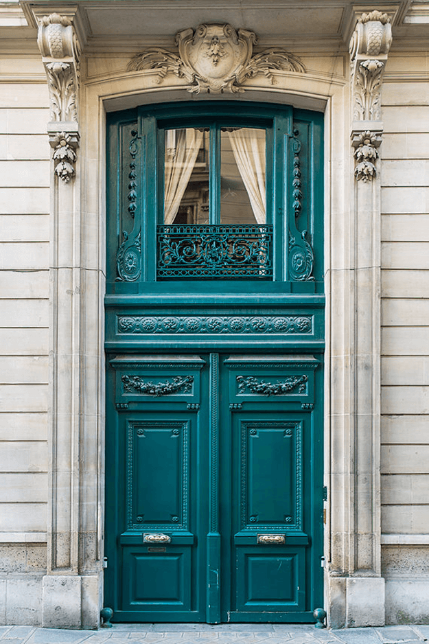 teal green french door in stone home front