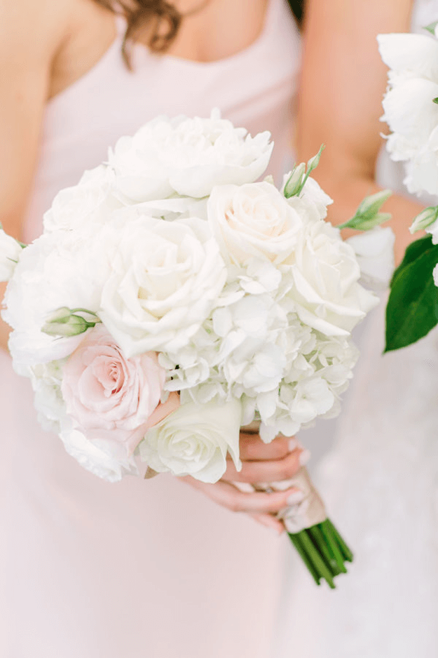 white bouquet with pale pink flowers and green accents