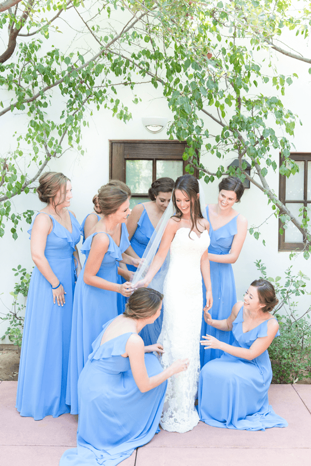 bridesmaids in french blue dresses surrounding bride