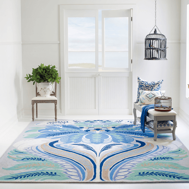 white coastal style interior with marine blue floral rug