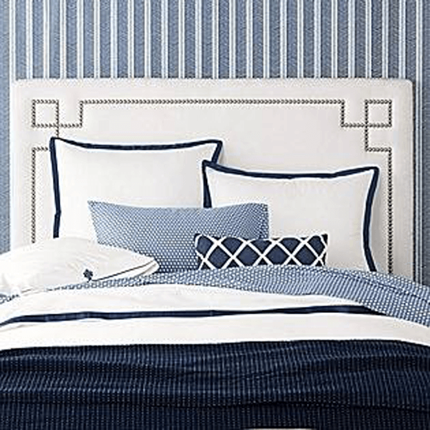 navy blue nad white bedroom with herringbone wallpaper