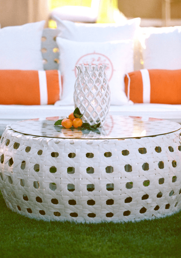 white outdoor furniture with orange accent piillows