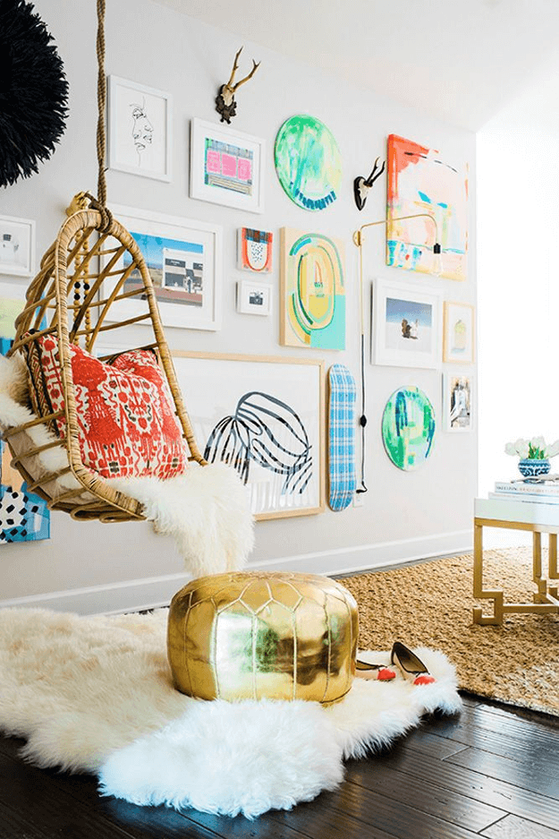 eclectic interior with swinging chair and bright red accents