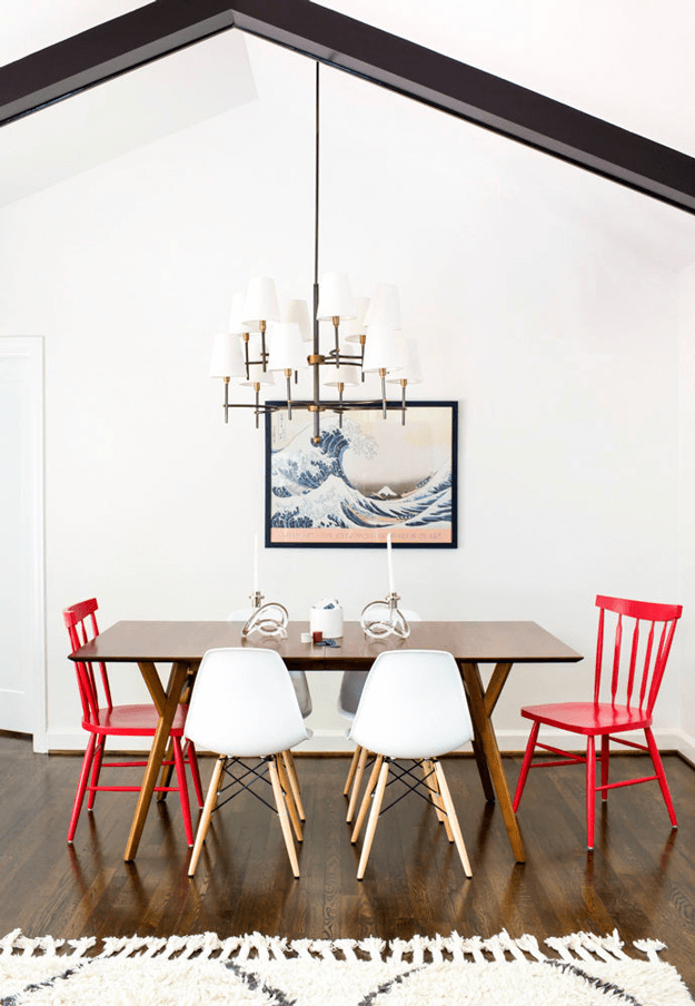 white mid-century style dining room with bright red chairs