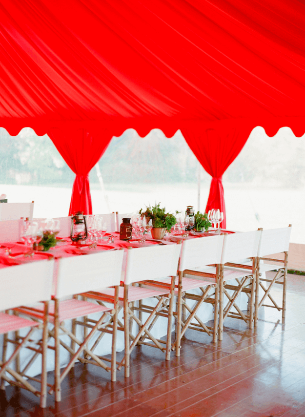 wedding reception with bright red tent