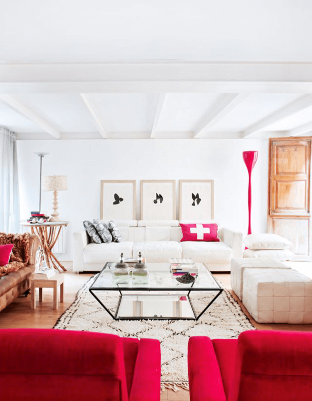 white living room with bright red accents