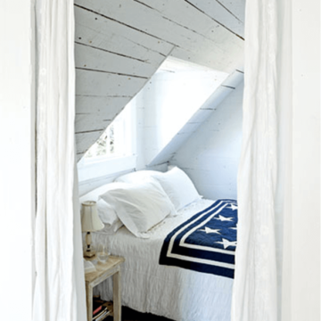 white cottage style bedroom with american flag throw blanket