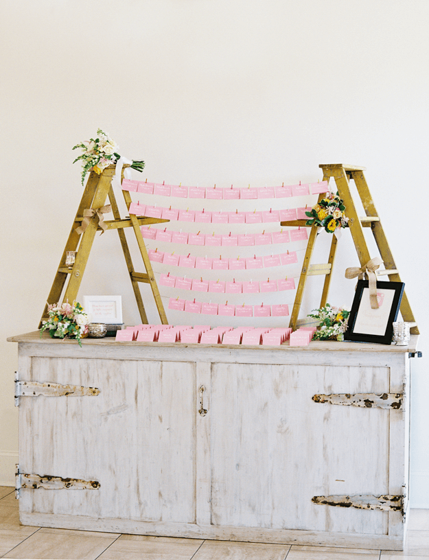 pink place cards on weathered gray console