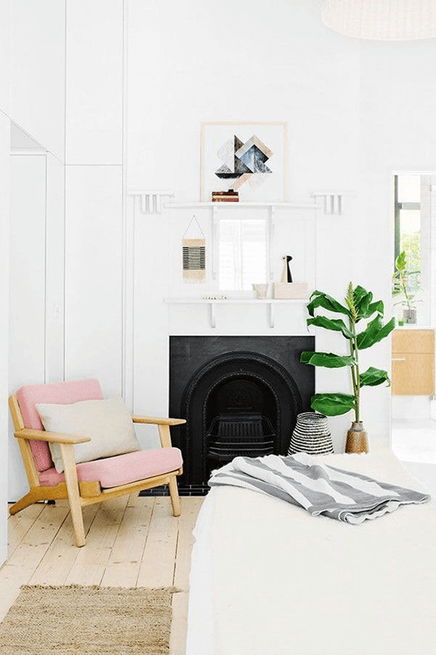 white bedroom with blush pink and light woods